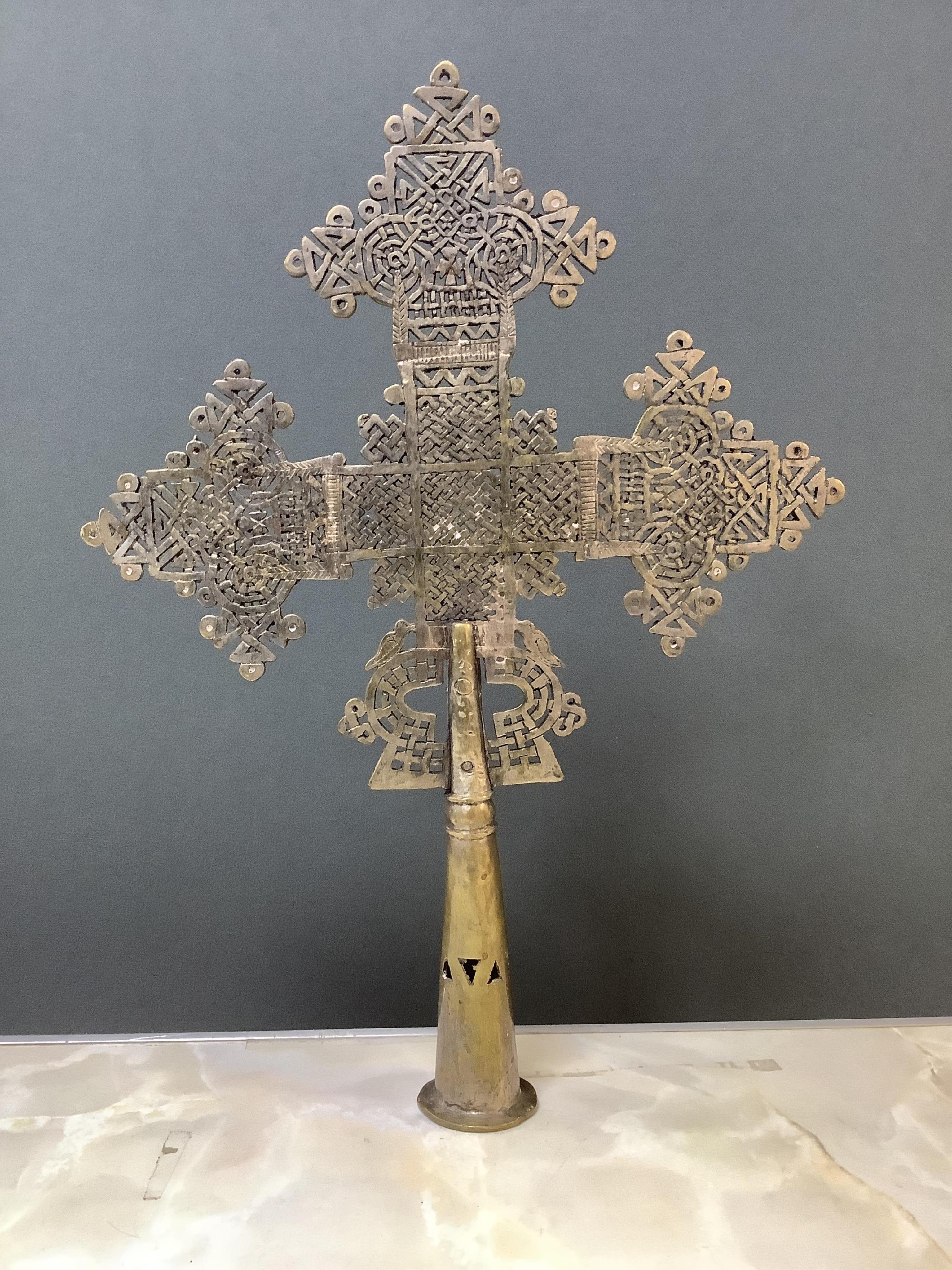 An Ethiopian Coptic processional cross, two Indian brass betel nut boxes together with other metalware and a set of miniature paintings, largest 51cm high. Condition - fair